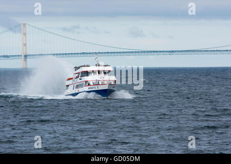 Michigan, Lake Michigan. Star Line Ferry in front of Mackinac Bridge (aka Big Mac or Mighty Mac). Stock Photo