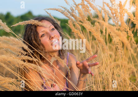Young beautiful woman in a field of wheat Stock Photo