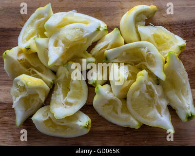 Lemons freshly squeezed on a wooden background Stock Photo