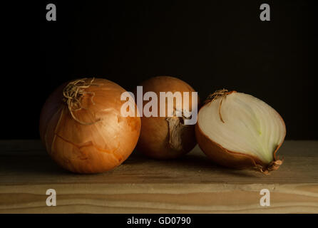 Onions on a wooden board Stock Photo