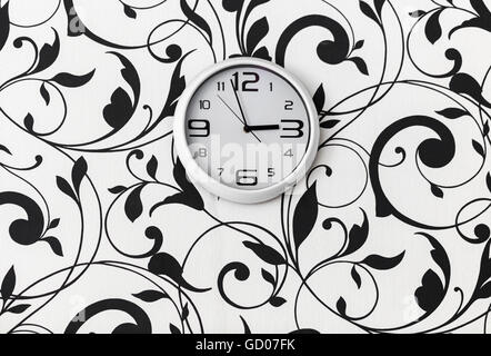 white round clock hanging on the wall Stock Photo