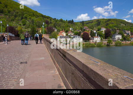 Visitors stroll the Old Bridge (or 'Alte Brucke') a classic stone bridge rebuilt from 1786 to 1788 in Heidelberg, Germany. Stock Photo