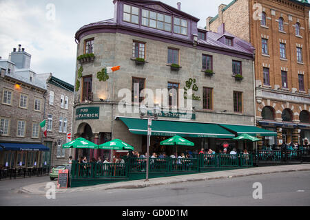 QUEBEC CITY - MAY 25, 2016: Rue St. Jean in old Quebec City is lined with quaint shops and restaurants which draw millions of to Stock Photo