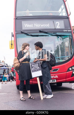 Brixton, London, UK. 9th July 2016. Young protesters blocking a bus on Brixton high street. Hundreds of Black Lives Matter Supporters marched on the local police station before a sit-in protest on Brixton High Street which brought London streets to standstill. The march is in response to the fatal shootings of Philando Castile in Minnesota and Alton Sterling in Louisiana. Credit:  Nicola Ferrari/Alamy Live News. Stock Photo