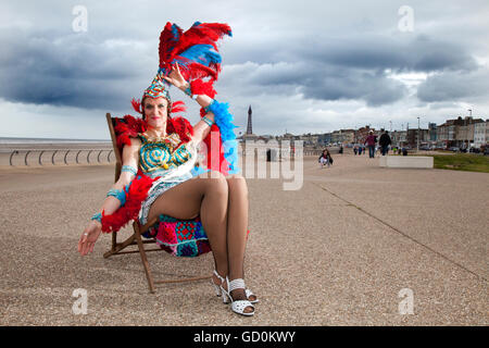 Blackpool, UK. 10th July, 2016. Showgirl 'Miss Informed' and knitters from around the UK were welcomed to Blackpool sea front to spin their own yarn in an attempt to break the Guinness World Record for simultaneous knitting.  The hardy wool warriors were faced with a blustery cool breeze but were able to knit themselves warm.  The current world record stands at 3089 people & with the assistance of the Town Crier 'Barry McQueen', new recruits were summoned from pavements & were more than happy to join in the fun. Credit:  Cernan Elias/Alamy Live News Stock Photo