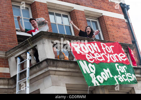 London, UK. 10th July 2016. Activists on one of the balcones of the former Police Station close to one of the entrances to the Mayor's Newham Show with a banner 'Room for everyone - No Room for racists'. Credit:  Peter Marshall/Alamy Live News Stock Photo