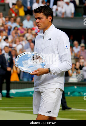 London, UK. 10th July, 2016. The Wimbledon Tennis Championships Day 14. The Final of the Men's Singles between Andy Murray (GBR) (2) and Milos Raonic (CAN) (6). Milos Raonic (CAN) holds his runners up trophy after Andy Murray (GBR) defeated him in straight sets in today's final. Credit:  Action Plus Sports/Alamy Live News Stock Photo