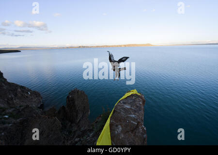 (160711) -- XINING, July 11, 2016 (Xinhua) -- An eagle flies over the Gyaring Lake in Madoi County of Tibetan Autonomous Prefecture of Golog, northwest China's Qinghai Province, July 31, 2014. Over the past decade, lots of efforts have been devoted to rehabilitate the fragile eco-system of Sanjiangyuan and the ecological degrading has been basically curbed. However, there are still problems ranging from overlapping authority, weak law enforcement, lack of public awareness and a conflict between ecological protection and people's need for higher incomes. The Sanjiangyuan National Park has Stock Photo