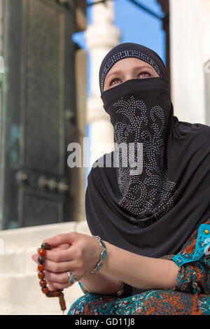 Portrait of Arabic Lady sitting Marble Steps of Blue Mosque Stock Photo