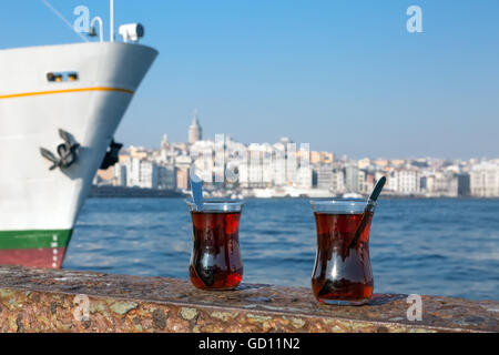 Turkish Tea glassy cups located on seafront parapet Stock Photo