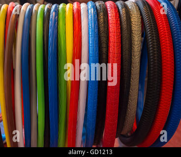 Many colored bicycle tires hanging close Stock Photo