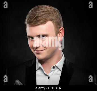 Portrait of a funny man over dark background. Stock Photo