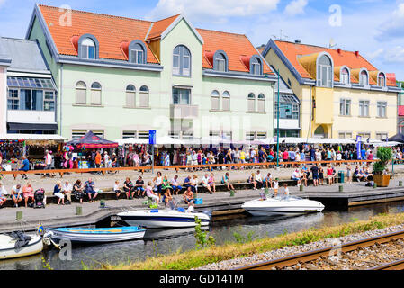 Ronneby, Sweden - July 9, 2016: Big public market day in town with lots of people along the river. Stock Photo