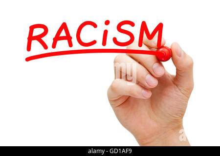 Hand writing Racism with red marker on transparent wipe board. Stock Photo