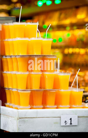Plastic glasses with orange juice Stock Photo