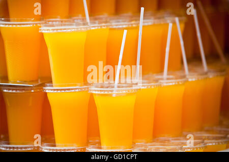 Plastic glasses with orange juice Stock Photo