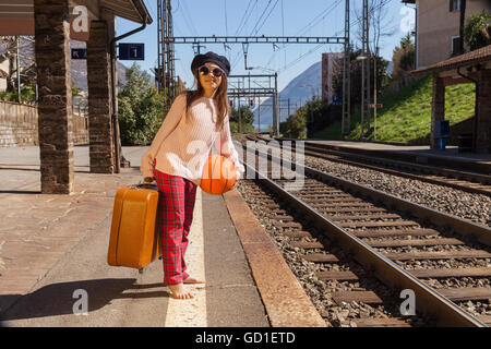 little girl waiting for the train in a deserted station Stock Photo