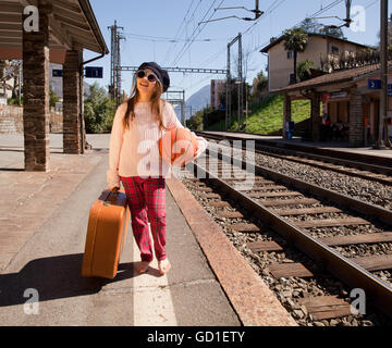 Little girl walks in with a balloon and pack station Stock Photo