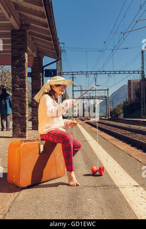 little girl waiting for the train in a deserted station Stock Photo