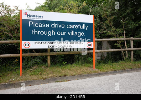 Sign on the quarry exit asking truck drivers to drive carefully through the village of Cheddar,Somerset. 17th July 2016 Stock Photo