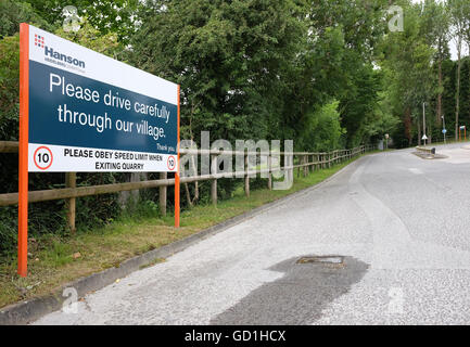 Sign on the quarry exit asking truck drivers to drive carefully through the village of Cheddar,Somerset. 17th July 2016 Stock Photo