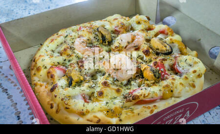 Fresh pizza in cardboard box on  table closeup Stock Photo