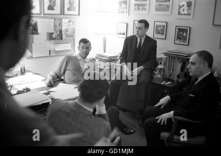 Johnny Carson meets with his staff in his office, on the set of the Tonight Show, 1963 Stock Photo