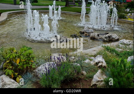 Group from small water fountains flowing in front beauty rockery, Sofia, Bulgaria Stock Photo