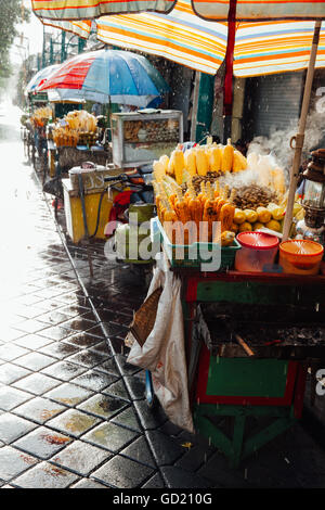 Street food stall with grilled corn under the rain, Ubud, Bali, Indonesia Stock Photo