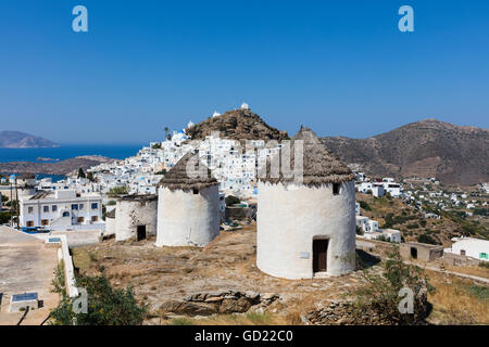 A typical Greek village perched on a rock with white and blue houses and quaint windmills, Ios, Cyclades, Greek Islands, Greece Stock Photo