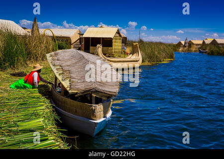 Quechua Indian family on Floating Grass islands of Uros, Lake Titicaca, Peru, South America Stock Photo