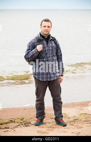 Young male caucasian traveler in red hat and summer hiking outfit enjoying  a waterfall during his single trip at the wooden mountains, back view Stock  Photo - Alamy