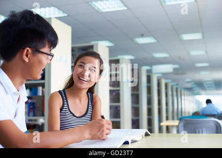 Young asian or Chinese college students study together in the library Stock Photo