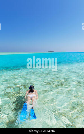 Woman snorkelling in lagoon, Rasdhoo Island, Northern Ari Atoll, Maldives, Indian Ocean, Asia Stock Photo