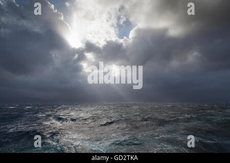 Sun rays breaking through storm clouds over the Foveaux Strait, New Zealand Stock Photo