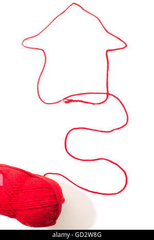 creative image of a house with red woolen threads on a white background Stock Photo
