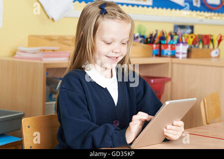 Female Elementary School Pupil Using Digital Tablet In Class Stock Photo
