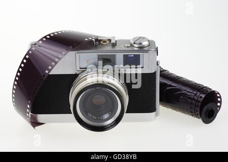 Old rangefinder analog camera system 135 and the photographic film on the white background. Stock Photo