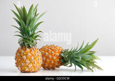 Ripe pineapple on a white table Stock Photo
