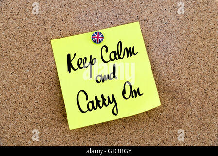Yellow paper note pinned on cork board with Great Britain flag thumbtack, written text KEEP CALM AND CARRY ON, United Kingdom exit from European Union Stock Photo