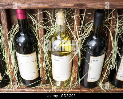 Wine bottles on the wooden shelf. Stock Photo