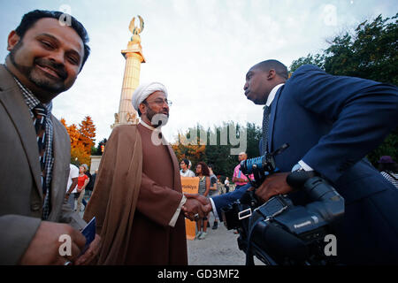 New York City, United States. 11th July, 2016. Imam Sakhawat Hussain chats with press after ceremony. Hundreds gathered at Brooklyn's Grand Army Plaza for a candlelight vigil sponsored by the Diocese of Brooklyn opposing recent incidents of violence against police officers & African-American civilians at the hands of police Credit:  Andy Katz/Pacific Press/Alamy Live News Stock Photo