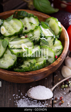 Pickled cucumber in a rustic wooden bowl Stock Photo