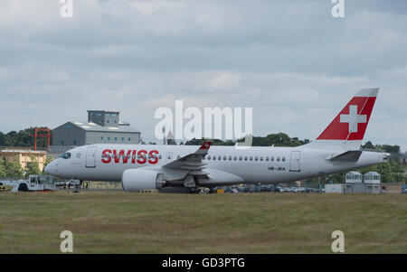 Farnborough, Hampshire UK. 11th July 2016. Bombardier’s first 125 seat CS100 aircraft supplied to airline operator Swiss takes off from The Farnborough International Trade Show before entering service on 15 July between Zurich and Paris Charles de Gaulle. The superquiet jet makes a flypast before departing Farnborough. Credit:  aviationimages/Alamy Live News. Stock Photo