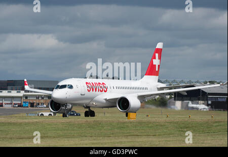 Farnborough, Hampshire UK. 11th July 2016. Bombardier’s first 125 seat CS100 aircraft supplied to airline operator Swiss takes off from The Farnborough International Trade Show before entering service on 15 July between Zurich and Paris Charles de Gaulle. The superquiet jet makes a flypast before departing Farnborough. Credit:  aviationimages/Alamy Live News. Stock Photo