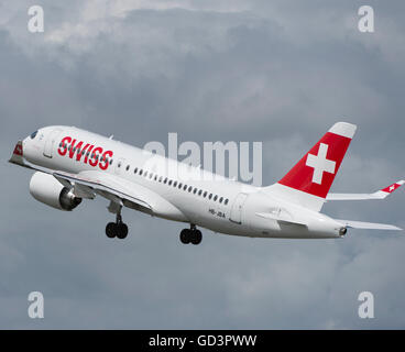 Farnborough, Hampshire UK. 11th July 2016. Bombardier’s first 125 seat CS100 aircraft supplied to airline operator Swiss takes off from The Farnborough International Trade Show before entering service on 15 July between Zurich and Paris Charles de Gaulle. The superquiet jet makes a flypast before departing Farnborough. Credit:  aviationimages/Alamy Live News. Stock Photo