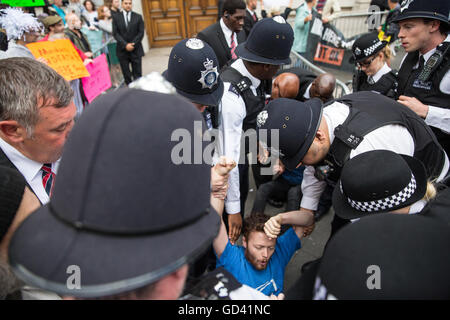 London, UK. 11th July, 2016. Human rights campaigners block the entrance to an official reception for the Farnborough International arms fair attended by arms dealers at the Science Museum. Protesters, from the Campaign Against Arms Trade, were objecting in particular to arms sales to Saudi Arabia, used in human rights abuses against the Yemeni people. Credit:  Mark Kerrison/Alamy Live News Stock Photo