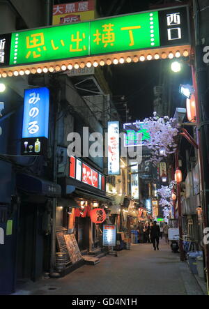 People visit Omoide Yokocho bar street in Shinjuku Tokyo Japan providing a delightful journey back in the post World War II days Stock Photo