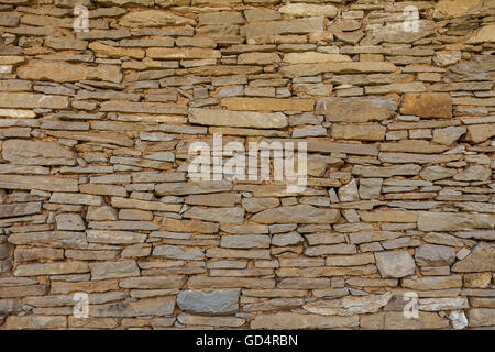 A stone wall of a fence built of old stones Stock Photo