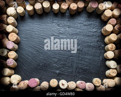 Wine corks arranged as frame on the graphite board. Stock Photo